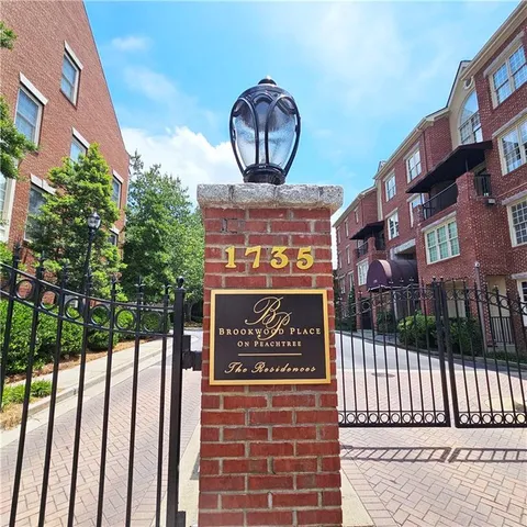 a living room with furniture a chandelier and a fireplace