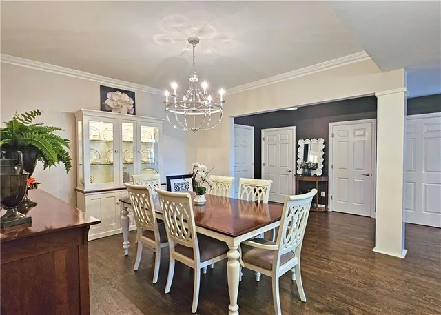 a view of a dining room with furniture wooden floor and chandelier
