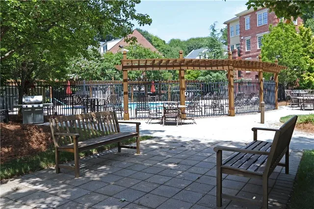 a view of a roof deck with table and chairs and potted plants