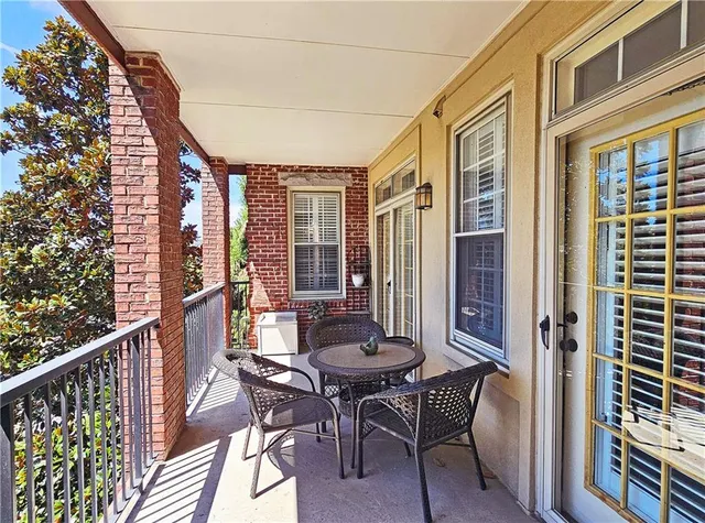 a view of a balcony dining area with furniture and wooden floor