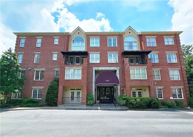 a view of a hallway with wooden floor and closet