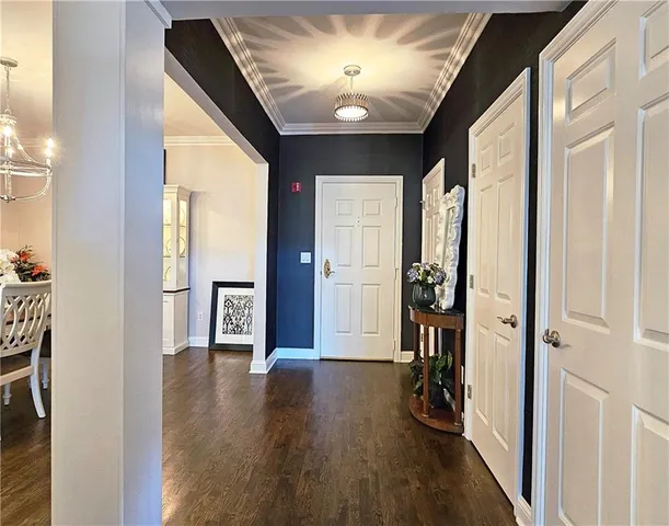 a view of a dining room with furniture wooden floor and chandelier