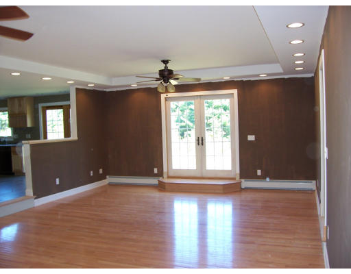 183 Monson Turnpike Road Petersham, MA 01366 - Photo 8 of 19 a view of an empty room with a window and wooden floor