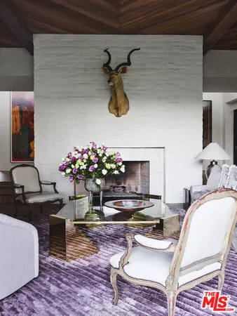 a living room with furniture and flowers