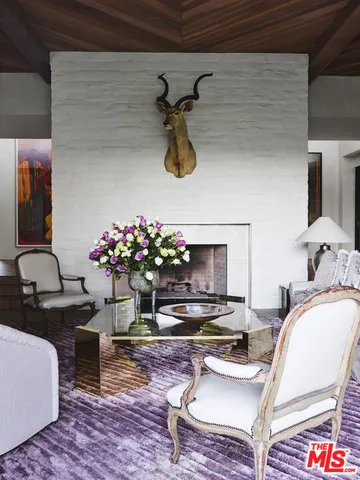 a living room with furniture and flowers