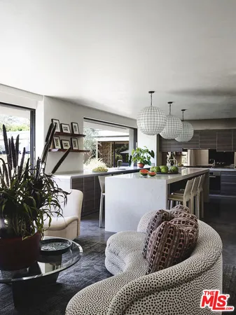 a kitchen with cabinets and chairs