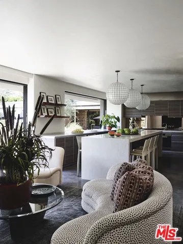 a kitchen with cabinets and chairs