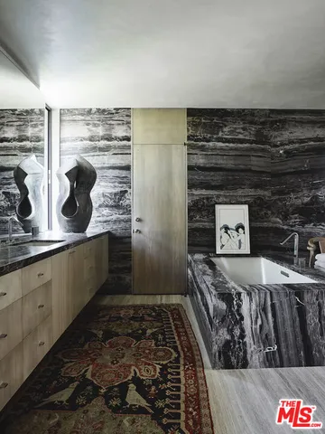 a view of a closet with wooden floor