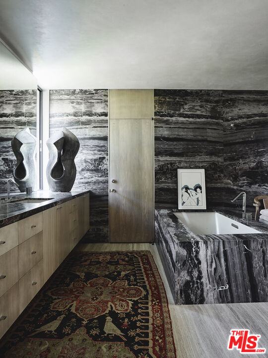 40471 Sand Dune Road Rancho Mirage, CA 92270 - Photo 18 of 42 a bathroom with a granite countertop sink and a mirror