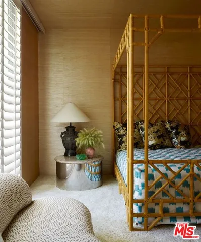 a spacious bedroom with a bed and a window