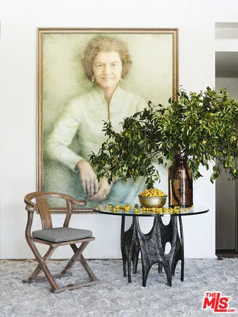 a view of a hallway with wooden floor and a potted plant