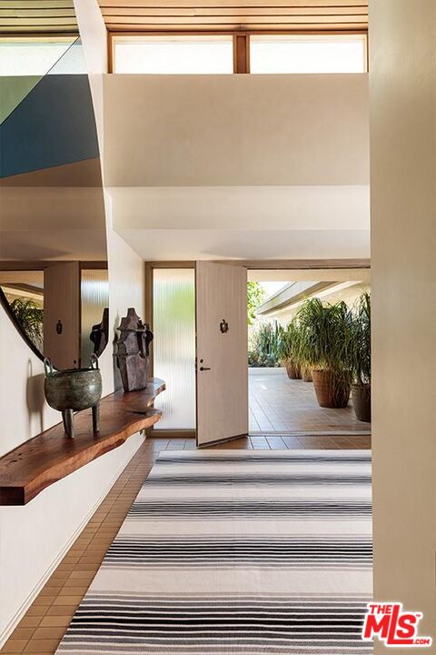 40471 Sand Dune Road Rancho Mirage, CA 92270 - Photo 8 of 42 a view of a hallway with wooden floor and a potted plant