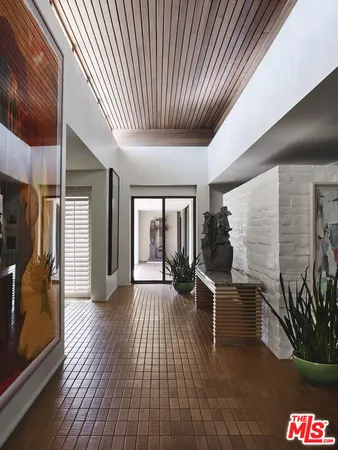 a living room with furniture and flowers