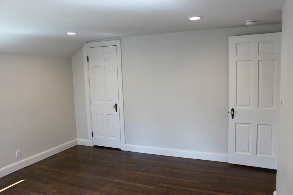 52 Roundwood Road Newton, MA 02464 - Photo 13 of 19 a view of an empty room with wooden floor