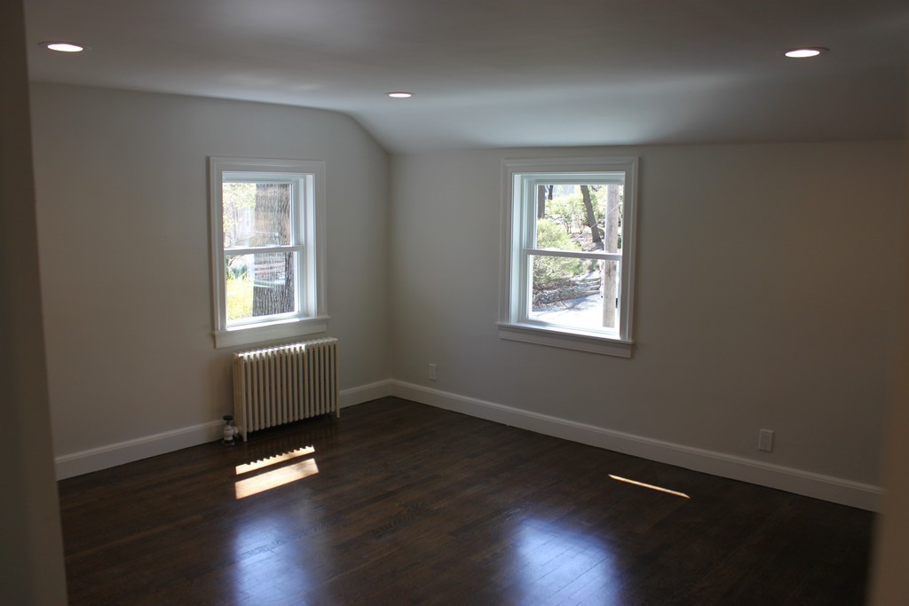 52 Roundwood Road Newton, MA 02464 - Photo 14 of 19 a view of an empty room with wooden floor and a window