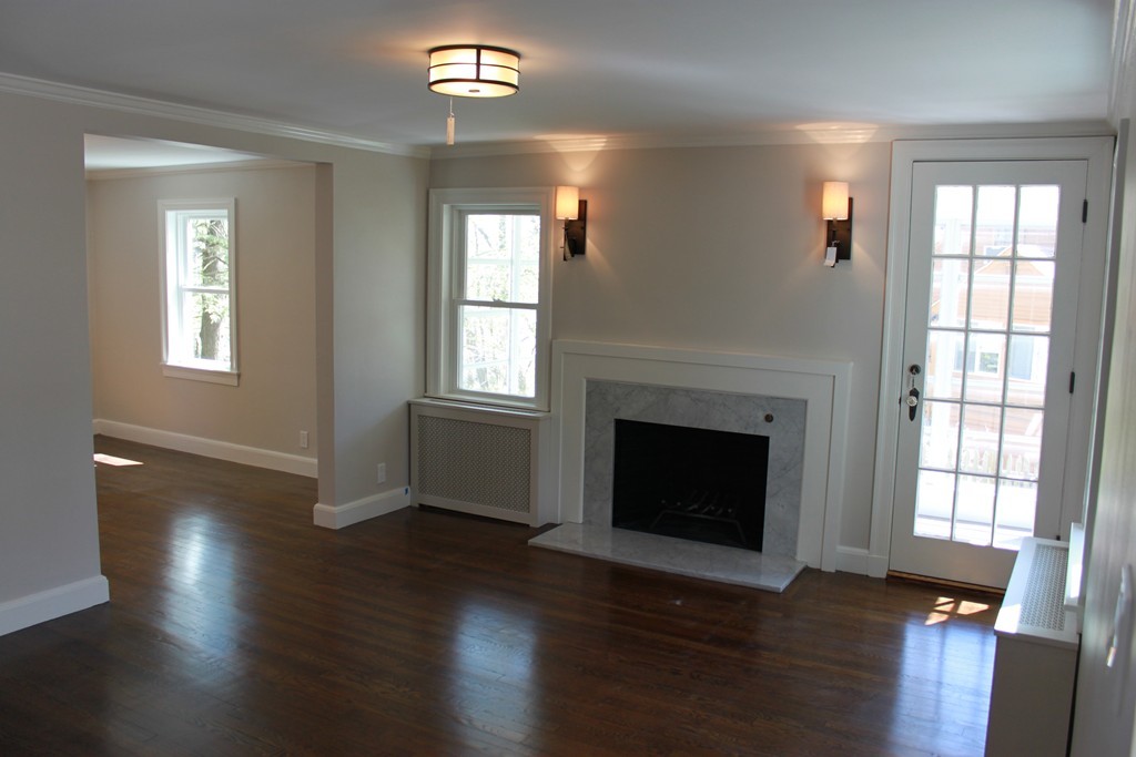 52 Roundwood Road Newton, MA 02464 - Photo 3 of 19 a view of an empty room with wooden floor and a window