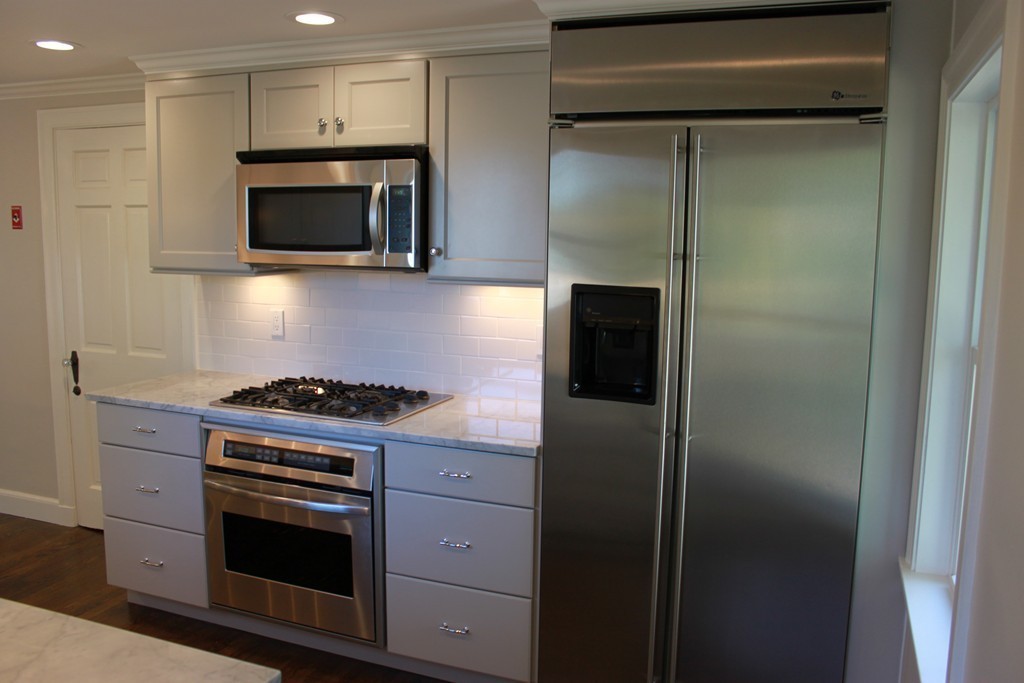 52 Roundwood Road Newton, MA 02464 - Photo 7 of 19 a kitchen with a stove and a microwave