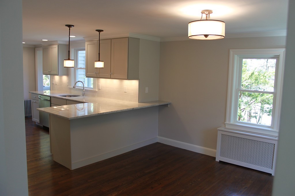 52 Roundwood Road Newton, MA 02464 - Photo 9 of 19 a kitchen with a sink chandelier and wooden floor