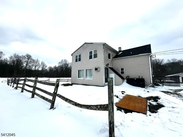 a view of a house with a snow in the background