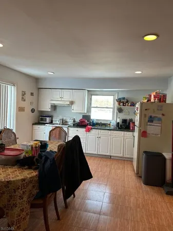 a view of a dining room with furniture and chandelier