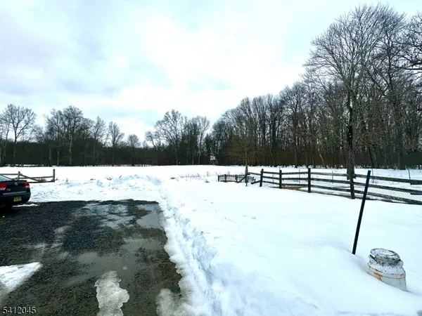 a view of yard covered in snow