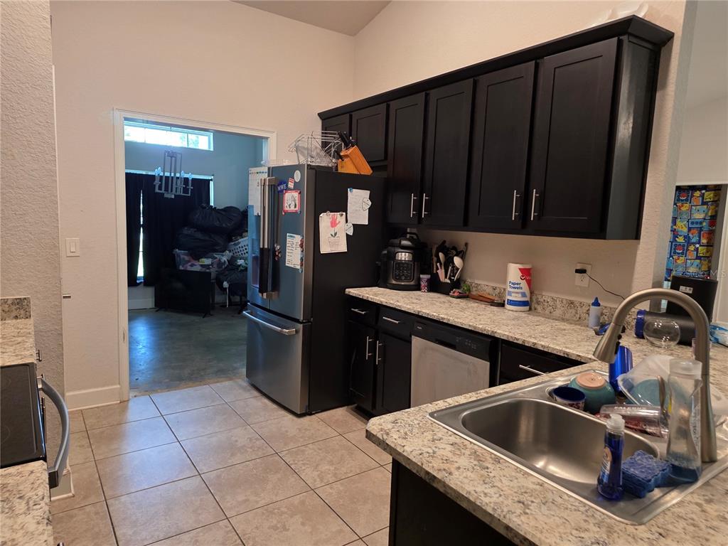 9 Cedar Run Ocala, FL 34472 - Photo 4 of 15 a kitchen with a sink refrigerator and cabinets