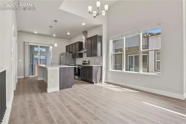 a view of kitchen with granite countertop cabinets and refrigerator