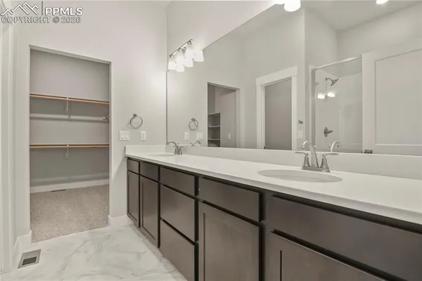 a bathroom with a double vanity sink and a mirror