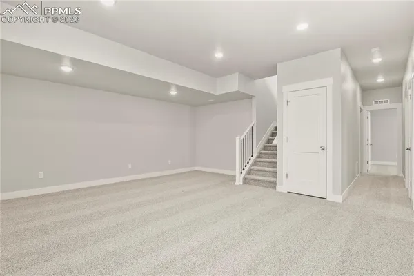 a view of an empty room with stairs