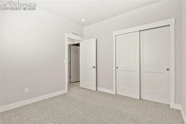 a view of a balcony with wooden floor and front door
