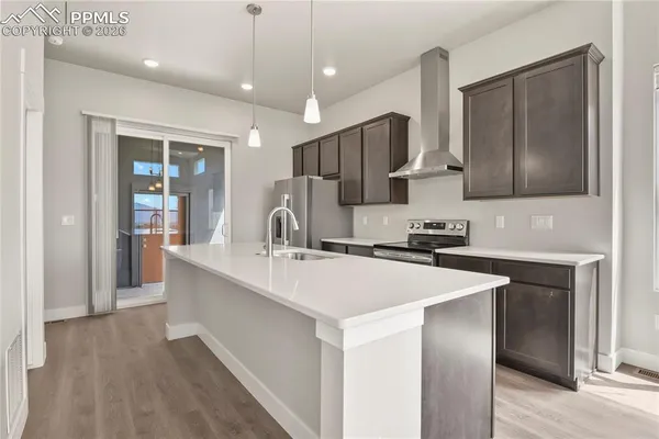 a kitchen with kitchen island a sink stainless steel appliances and cabinets