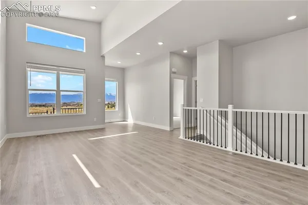 a view of an entryway with wooden floor