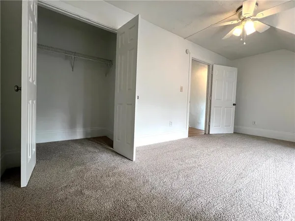 an empty room with a empty space and a ceiling fan