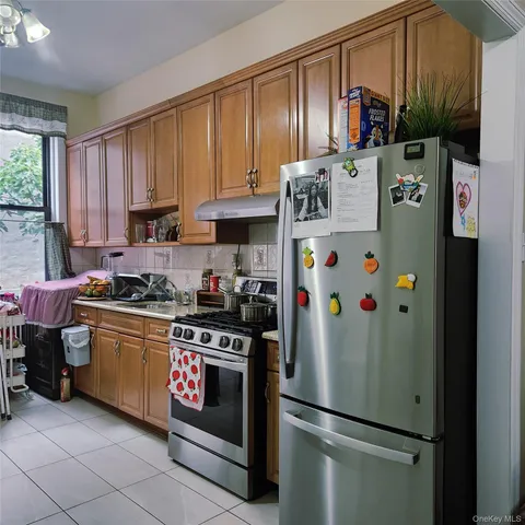 a kitchen with stainless steel appliances granite countertop a refrigerator and a stove
