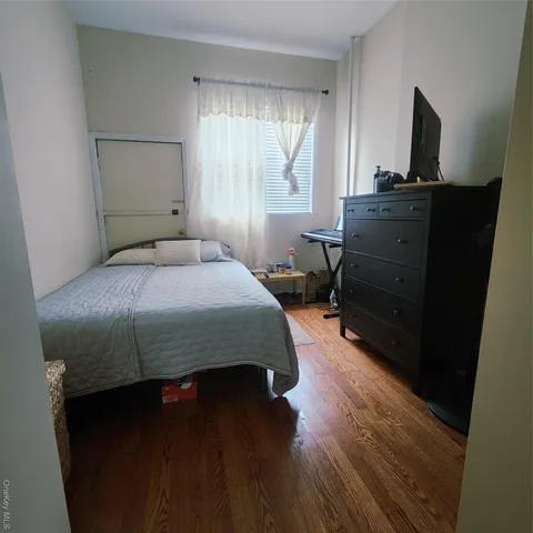 a bedroom with a bed and a desk in it