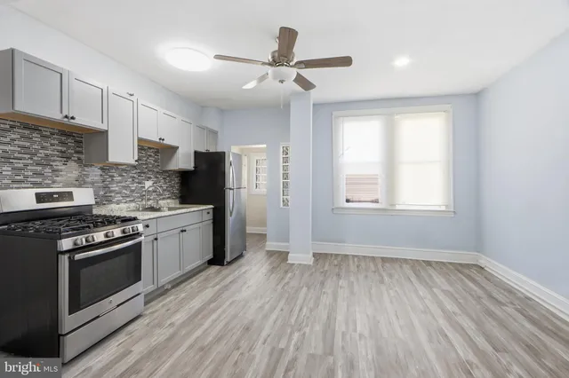 a kitchen with stainless steel appliances granite countertop a stove a refrigerator and a sink