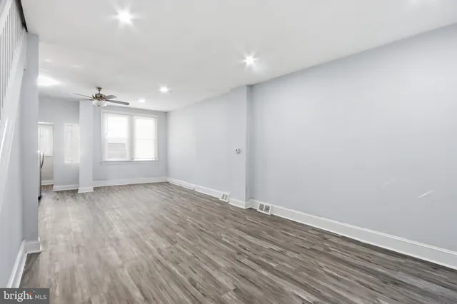 wooden floor in an empty room with a window