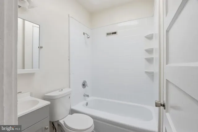 a bathroom with a toilet and a bathtub