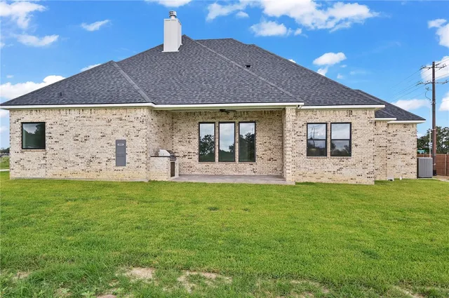 a view of an empty room with window and closet area