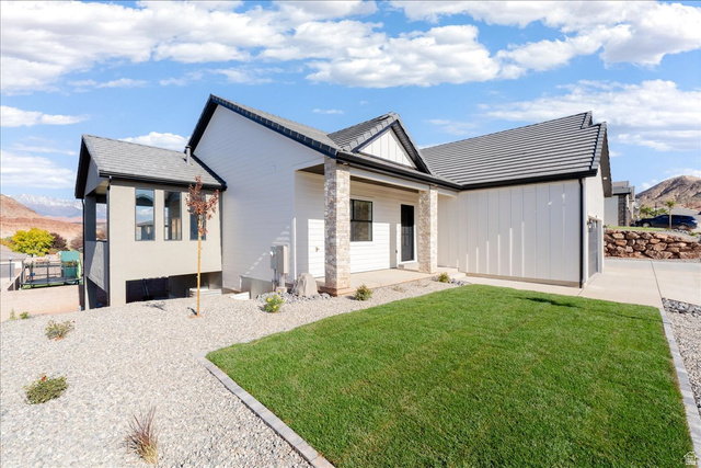 1491 East Centaurus Way, Unit 86 Washington, UT 84780 - Photo 20 of 26 View of front facade with a front yard, board and batten siding, and a porch