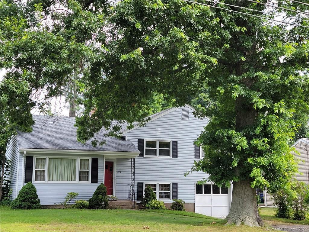 216 Reservoir Road Newington, CT 06111 - Photo 1 of 1 a front view of a house with a garden and yard