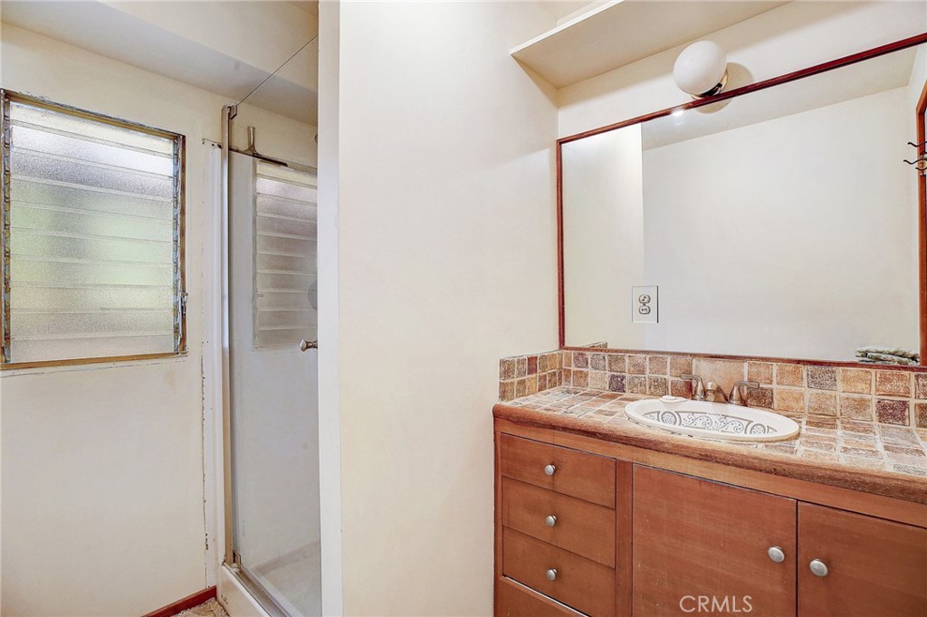 755 Crane Boulevard Los Angeles, CA 90065 - Photo 16 of 40 a bathroom with a granite countertop sink mirror and double