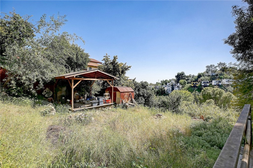 755 Crane Boulevard Los Angeles, CA 90065 - Photo 30 of 40 a view of a wooden house with a yard and large trees