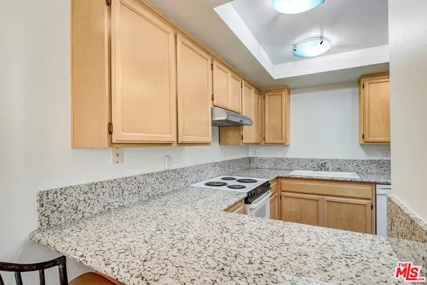 a kitchen with stainless steel appliances granite countertop a sink a microwave cabinets and a stove