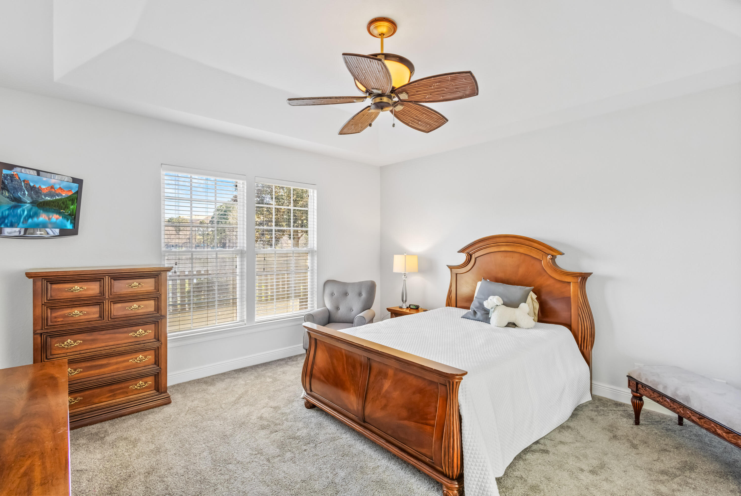 4248 Jade Loop Destin, FL 32541 - Photo 17 of 46 a bedroom with a bed a dresser and a window