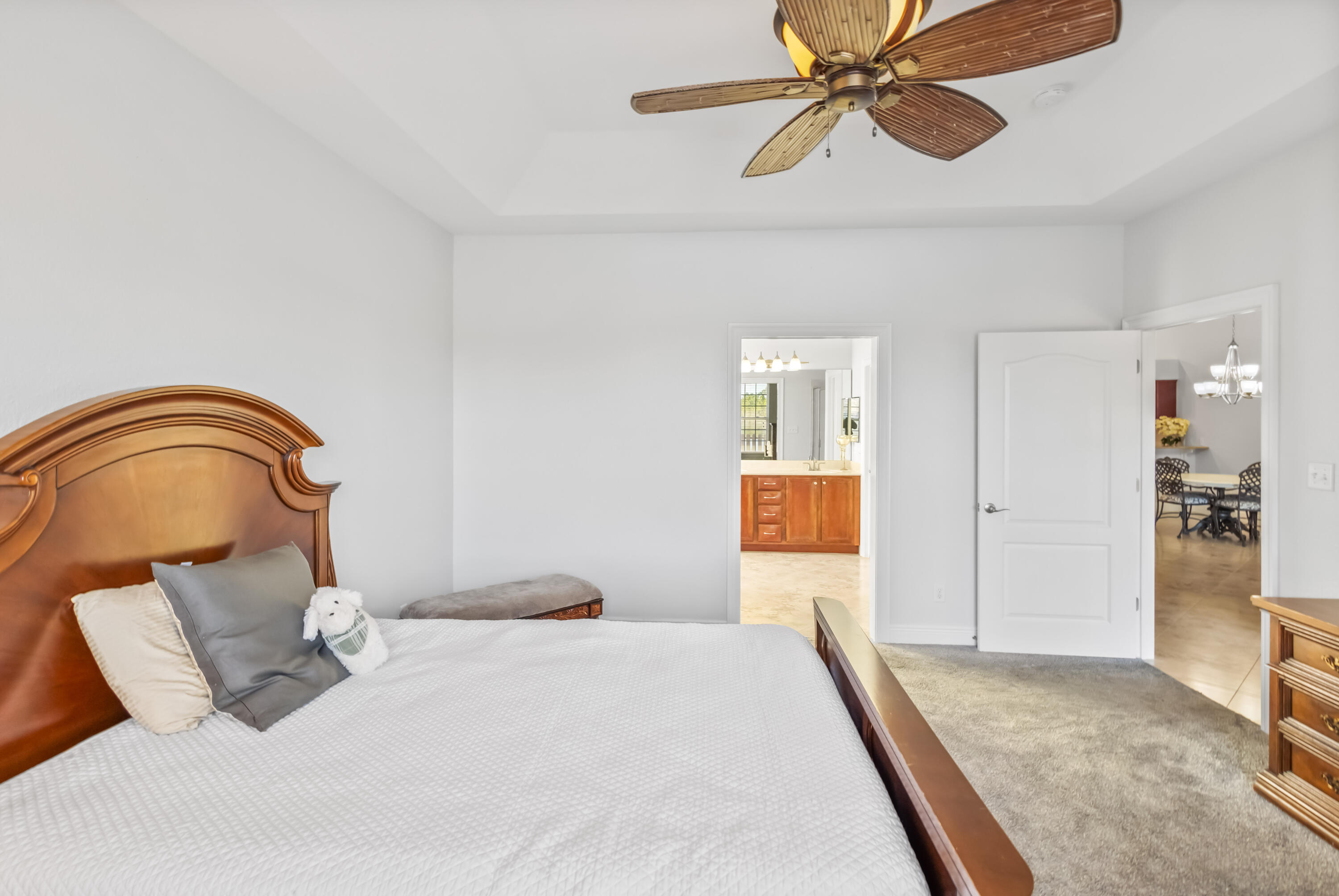 4248 Jade Loop Destin, FL 32541 - Photo 19 of 46 a bedroom with a bed and a chandelier