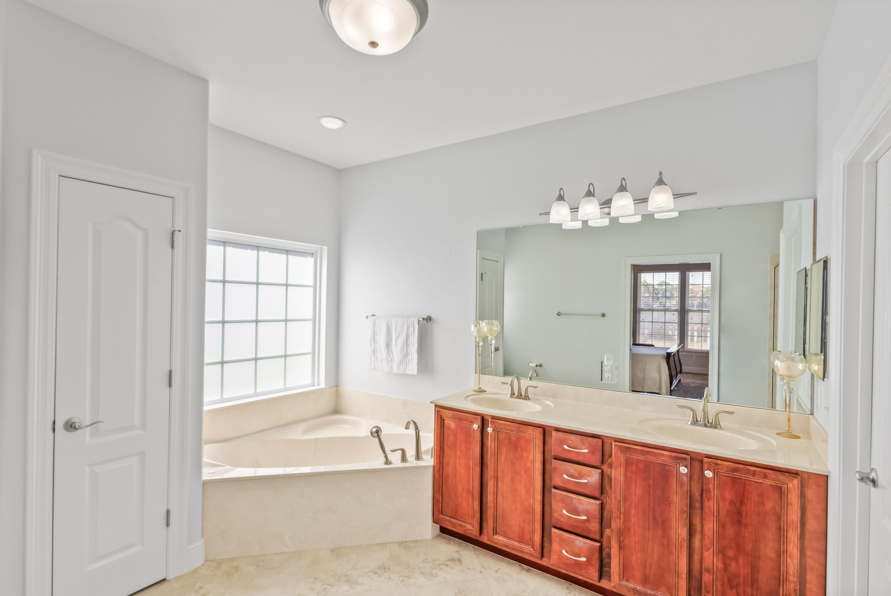 4248 Jade Loop Destin, FL 32541 - Photo 22 of 46 a spacious bathroom with a tub sink and mirror