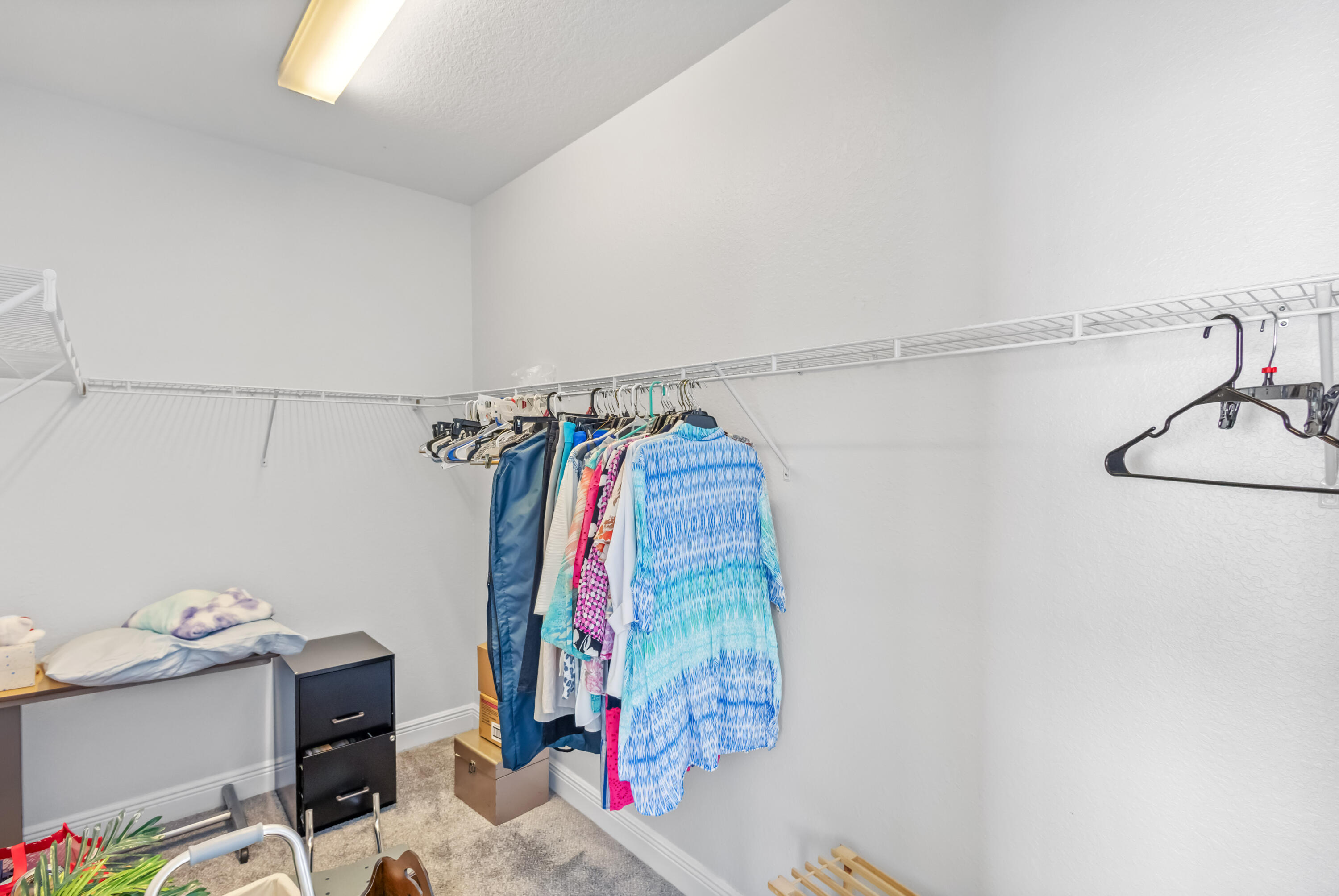 4248 Jade Loop Destin, FL 32541 - Photo 23 of 46 a view of walk in closet with clothes and shoes