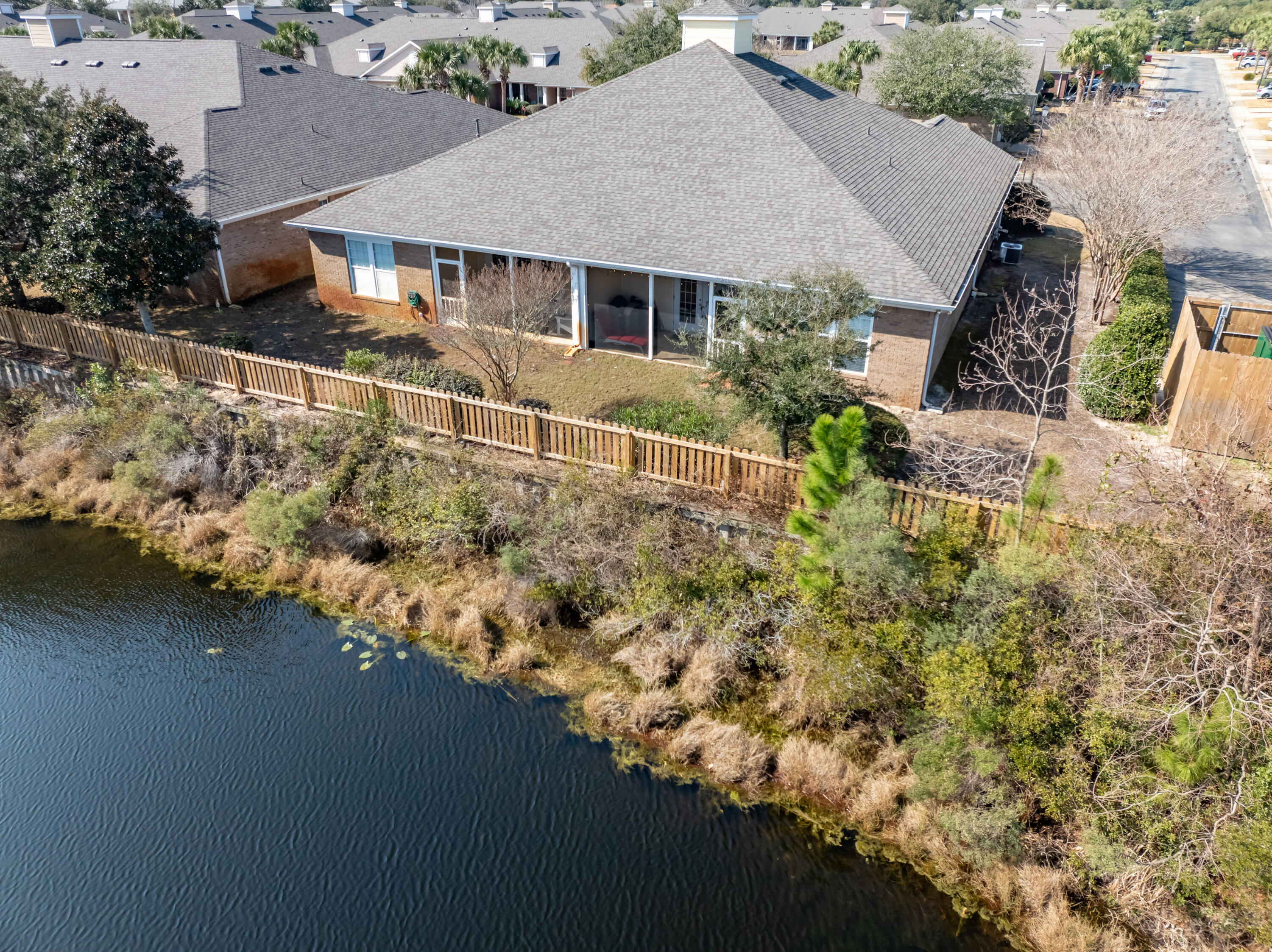 4248 Jade Loop Destin, FL 32541 - Photo 39 of 46 an aerial view of house with yard and trees in the background