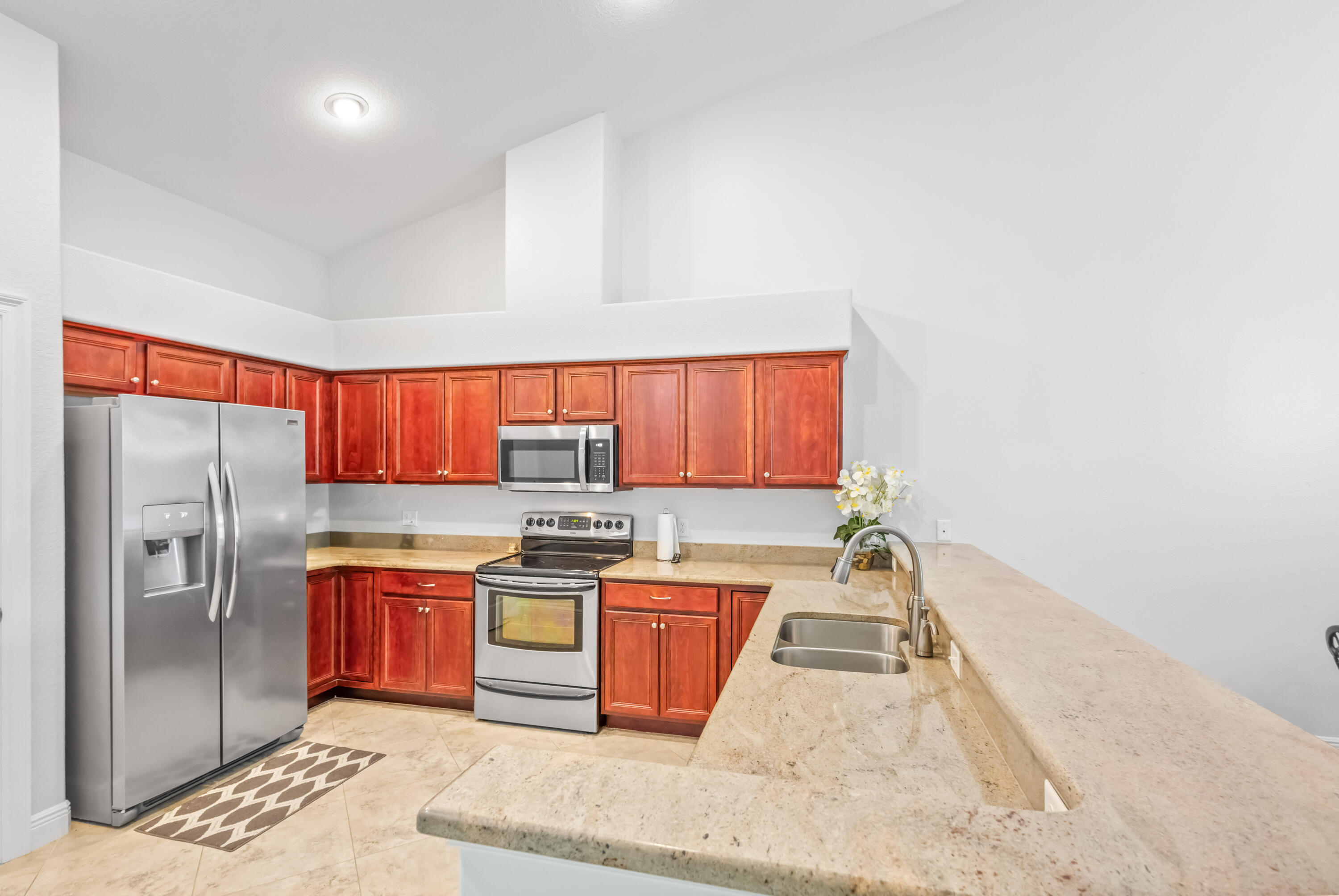 4248 Jade Loop Destin, FL 32541 - Photo 7 of 46 a kitchen with stainless steel appliances granite countertop a refrigerator sink and cabinets